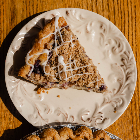 Slice of pie on a decorative white plate with a wooden background