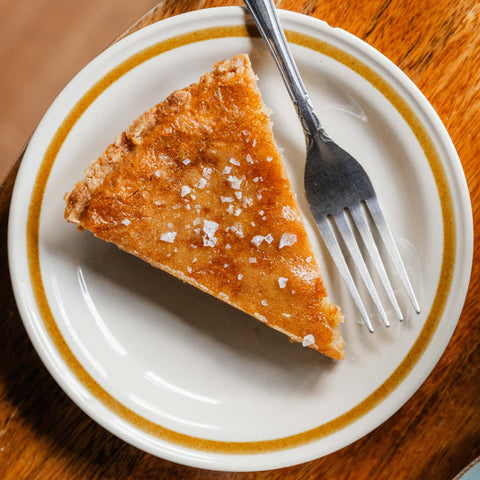 Slice of Brown Sugar Chess Pie on a plate with a fork